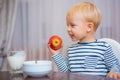 Child eat porridge. Kid cute boy blue eyes sit at table with plate and food. Healthy food. Boy cute baby eating Royalty Free Stock Photo