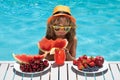 Child eat watermelon. Kid relaxing on sea beach or pool. Kid with summer fruits in pool. Child in swimming pool playing Royalty Free Stock Photo