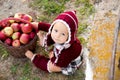 Child eating apples in a village in autumn. Little baby boy play