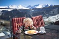 Child eating apres ski lunch. Winter snow fun for kids.