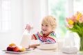 Child eating breakfast. Kid with milk and cereal Royalty Free Stock Photo