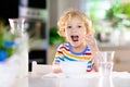 Child eating breakfast. Kid with milk and cereal Royalty Free Stock Photo