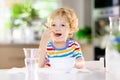 Child eating breakfast. Kid with milk and cereal Royalty Free Stock Photo