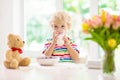 Child eating breakfast. Kid with milk and cereal Royalty Free Stock Photo