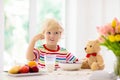 Child eating breakfast. Kid with milk and cereal Royalty Free Stock Photo