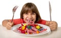 Child eating candy like crazy in sugar abuse and unhealthy sweet nutrition concept