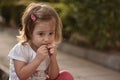 Child eating candy on the street