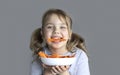 Child eating carrots. Healthy nutrition concept. Little kid eats vegetables. Caucasian girl poprtrait. Royalty Free Stock Photo