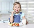 Child eating,caucasian little girl portrait,.small kid have a meal Royalty Free Stock Photo