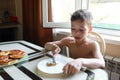 Child eating cheesecakes for breakfast Royalty Free Stock Photo