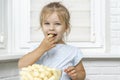 Child eating corn sticks at the kitchen Royalty Free Stock Photo