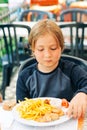 Child eating french fries and chicken nuggets in restaurant Royalty Free Stock Photo