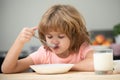 Child eating healthy food. Cute little boy having soup for lunch. Royalty Free Stock Photo