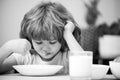 Child eating healthy food at home. Unhappy child have no appetite. Upset little kid refuse to eat organic cereals with Royalty Free Stock Photo