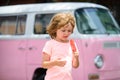 Child eating ice cream. Lovely sweet Caucasian kids outside.