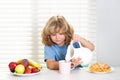 Child eating meal. Kid pouring whole cows milk. Healthy nutrition for children. Cute boy enjoy eating for morning Royalty Free Stock Photo