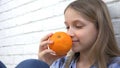 Child Eating Oranges Fruits at Breakfast, Girl Kid Smelling Healthy Food Kitchen Royalty Free Stock Photo