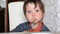 Child eating pasta at the table with a fork Royalty Free Stock Photo