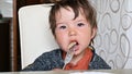 Child eating pasta at the table with a fork Royalty Free Stock Photo