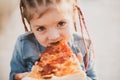 Child eating pizza. Fastfood for kids. Junkfood addiction. Italian cuisine. Children food. Childhood obesity. Tasty food