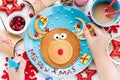 Child eating reindeer pancakes Christmas breakfast