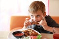 Child eating roasted chicken wings