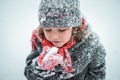 Child eating snow on winter fair. Kids eat toffee apples on Christmas market in snow. Outdoor fun on snowy day. Family