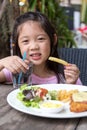 Child Eating Steak and Fries