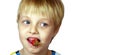 Child eating strawberries close-up. boy with strawberries isolated on white. copy space