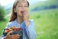 Child eating strawberries in a field Royalty Free Stock Photo