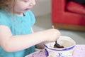 Child eating sweets pudding desert chocolate cake young kid girl with spoon and dish unhealthy Royalty Free Stock Photo