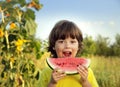 child eating watermelon in the garden Royalty Free Stock Photo