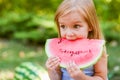 Child eating watermelon in the garden. Kids eat fruit outdoors. Healthy snack for children. 2 years old girl enjoying watermelon Royalty Free Stock Photo