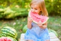 Child eating watermelon in the garden. Kids eat fruit outdoors. Healthy snack for children. 2 years old girl enjoying watermelon Royalty Free Stock Photo