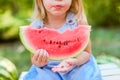 Child eating watermelon in the garden. Kids eat fruit outdoors. Healthy snack for children. 2 years old girl enjoying watermelon Royalty Free Stock Photo