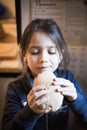Child eats big homemade bread Royalty Free Stock Photo
