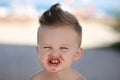 Child eats chokolate with full stength on a beach Royalty Free Stock Photo
