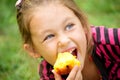 Child eats a peach Royalty Free Stock Photo