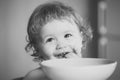 Child eats porridge. Portrait of little baby boy eating Royalty Free Stock Photo