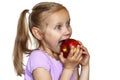 Child eats red apple Royalty Free Stock Photo