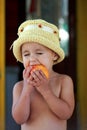 The child eats a tasty peach