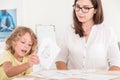 Child education therapist using props during a meeting with a kid with problems