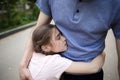 Child embraces dad tightly. family hugs of daddy and daughter