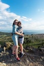 A child embraces mom in the mountain trip