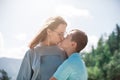 A child embraces mom in the mountain trip