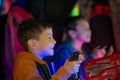 The child emotionally plays on gaming machines in entertainment