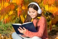 Child enjoy reading. Studying twice faster using visual and audio information. Girl read book on autumn day. Little