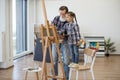 Child enjoying art making with grandpa in home studio