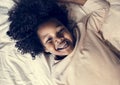 Child enjoying playing on bed alone