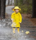 Child Enjoying The Rain In His Galoshes Royalty Free Stock Photo